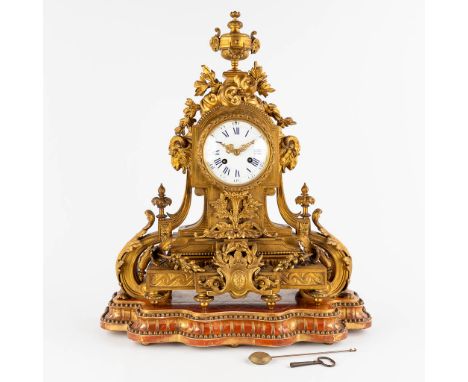 An antique mantle clockGilt bronze in a Louis XVI style, decorated with ram's heads.Movement marked 'Marti'.&nbsp;Circa 1880.