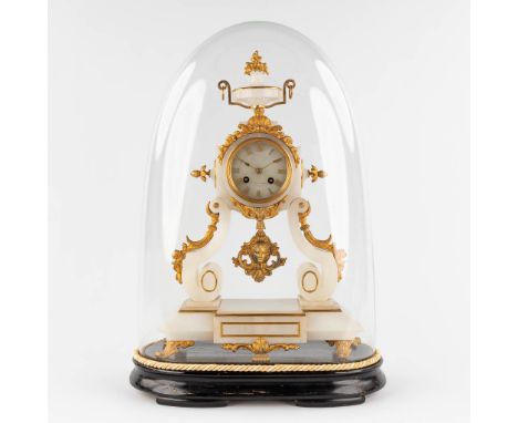 A mantle clock, alabaster mounted with gilt spelter standing under a glass dome. Circa 1900.&nbsp;Dial signed 'F. Lutzenrath 