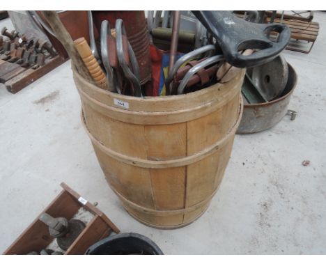 A barrel containing various shooting sticks, vintage carpet cleaner etc