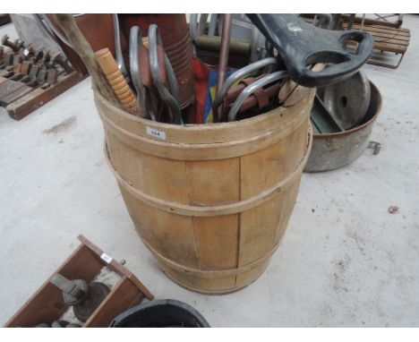 A barrel containing various shooting sticks, vintage carpet cleaner etc