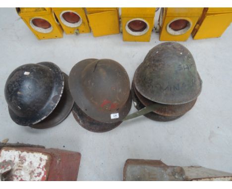 A selection of vintage metal military helmets