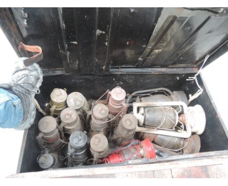 A tin trunk containing vintage lanterns