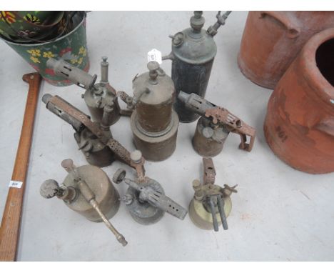 A selection of vintage copper and brass blow lamps