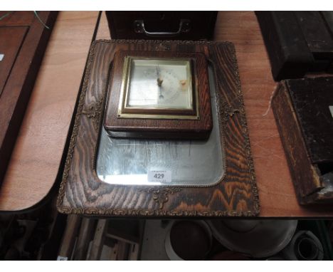 A wall mirror and barometer