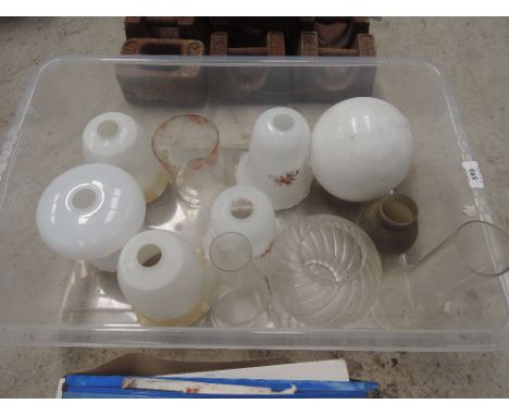 A box of various glass light shades and lamp chimneys