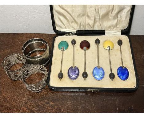 Silver and enamel coffee bean spoons together with three napkin rings.