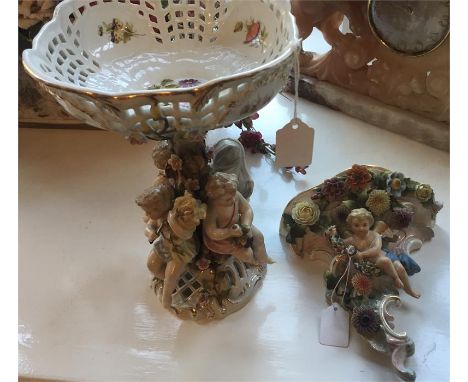 19thC porcelain bowl surrounded by putti (28cm h) and a 19thC porcelain wall bracket.