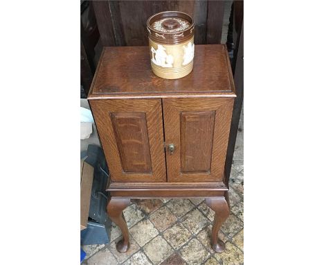 Edwardian oak smokers cabinet on cabriole legs with Doulton tobacco jar