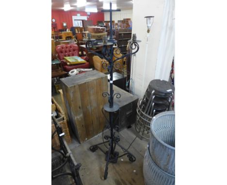 A Victorian ecclesiastical wrought iron candle stand converted to a lamp 