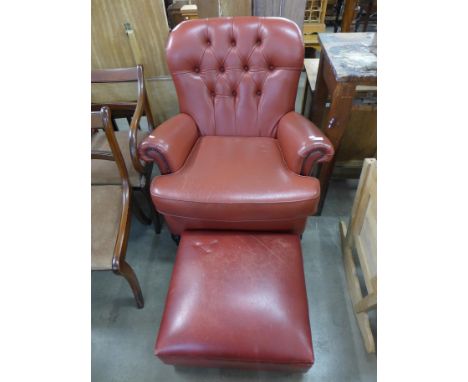 A red leather armchair and pouffe 