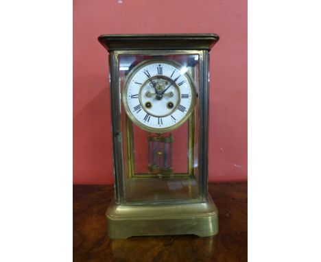 A brass, four glass regulator mantel clock with mercury pendulum and open escapement 