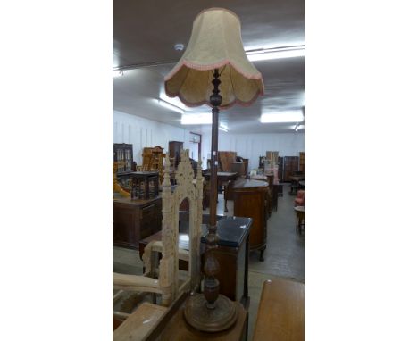 A carved oak standard lamp 