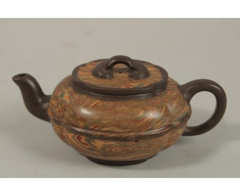 AN UNUSUAL CHINESE YIXING TEAPOT, of lobed form with naturalistic striations, the base and interior lid with impressed charac