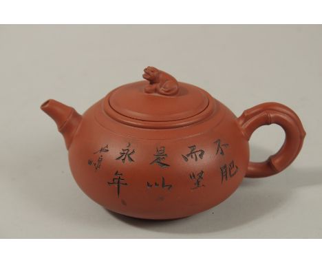 A CHINESE SQUAT-FORM YIXING TEAPOT, with incised flora and calligraphy, the lid with foo dog finial, base and inner lid beari