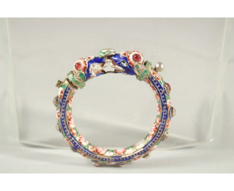 A VERY FINE 19TH CENTURY INDIAN ENAMELLED SILVER BANGLE, with two elephant heads, inset with red stones, 7.5cm wide.