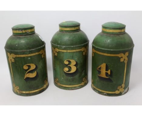 Set of three 19th century tin tea canisters, each numbered with original gilt paint work, 49cm high, together with another si