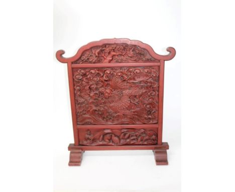 Antique Chinese cinnabar lacquer table screen, carved in high relief with central dragon amidst waves, the top panel with tre