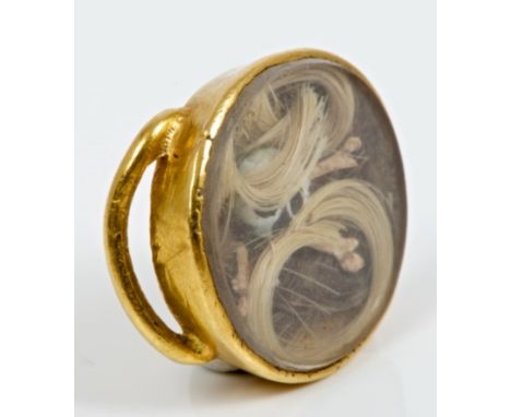 Late 17th century Momento Mori locket with an enamel skull and crossbones, set within locks of blonde and brown hair, in glaz