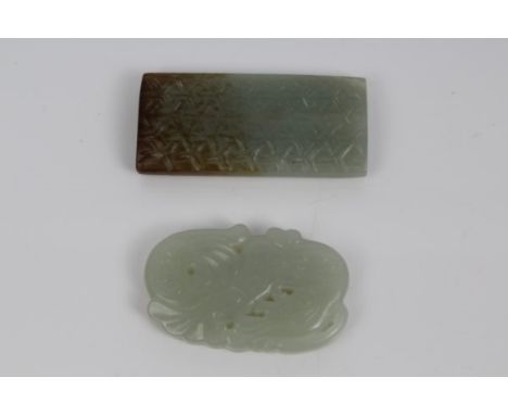 Two carved jade / green hardstone pendants, one of rectangular bowed form with geometric repeat ornament, the other in the fo