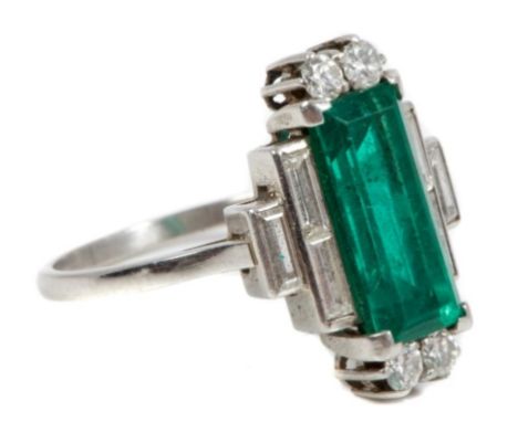 Fine Art Deco emerald and diamond cocktail ring with a rectangular step cut emerald flanked by four brilliant cut diamonds wi