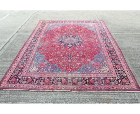 Traditional Mashad wool carpet with geometric floral decoration on blue, red and cream ground, 393cm x 290cm