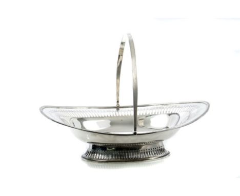 George V silver swing-handled cake basket of oval form, with pierced decoration, reeded border and reeded handles, on a pierc