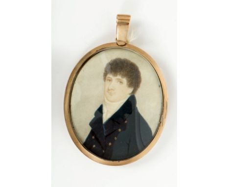 Georgian oval portrait miniature on ivory - a gentleman with curly hair and black coat, in oval yellow metal frame with glaze