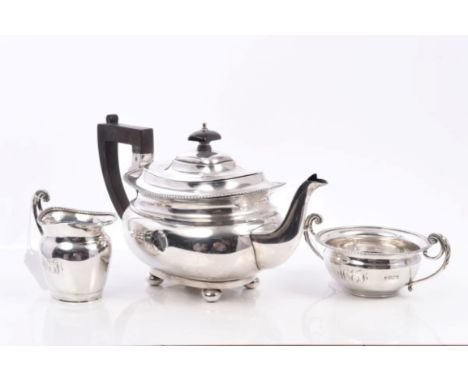 George V composite three piece silver tea set comprising teapot of compressed cauldron form, with gadrooned border, angular e