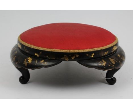 Late 19th / early 20th century Chinese black lacquer footstool of angular form, gilt decorated with floral sprays, on scroll 
