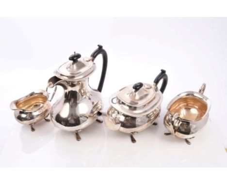 1920s silver four piece tea set comprising teapot of compressed baluster form, with ebony scroll handle and domed hinged cove