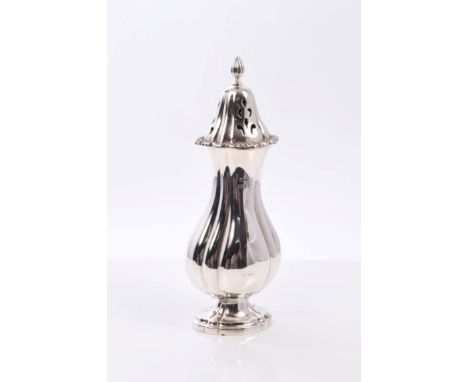 Contemporary silver sugar caster of fluted baluster form, with detachable pierced cover and flame finial on pedestal foot (Bi
