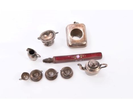 Miniature unmarked silver tea set comprising teapot, sugar dish, cream jug, four cups and saucers, together with a Victorian 