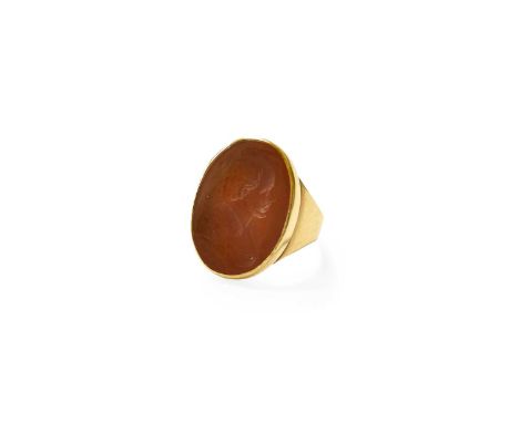 A Carnelian Intaglio Ring, the oval carnelian carved to depict a figure in profile, in a yellow rubbed over setting, to a pla