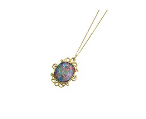 A Composite Opal Pendant on Chain, the oval composite opal in yellow rubbed over setting, within a scroll frame, stamped '9C'