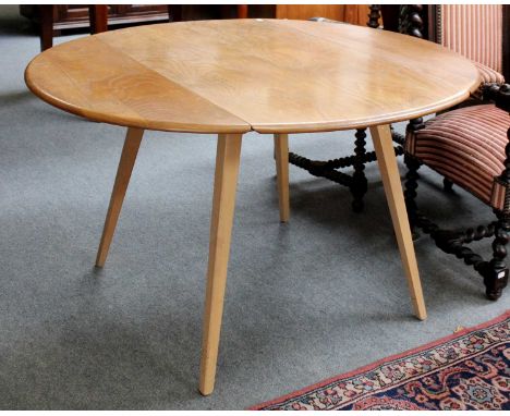 An Ercol Light Elm Drop Leaf Dining Table, 124cm by 114cm by 70cmSplit to one drop leaf. Polish scuffed, worn and faded. Leav