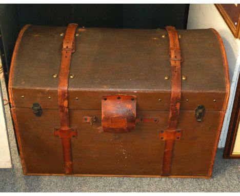 A canvas and leather domed top trunk with stenciled initials M C.  