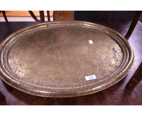 A 19th century heavy gauge Chinese brass oval platter, with moulded rim, the slightly dished interior engraved throughout wit