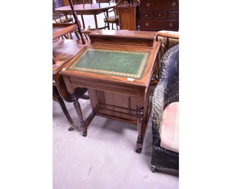 A Victorian mahogany davenport desk having raised back and turned supports