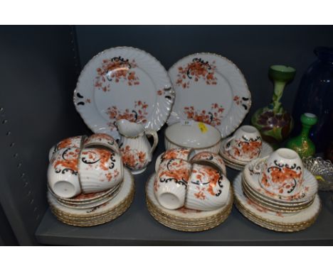 An antique part coffee service having orange and black floral pattern with gilt detailing includes cups and saucers,plates, s