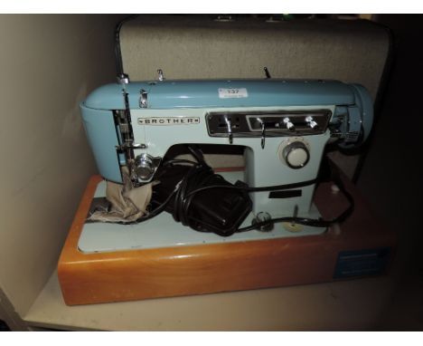 A vintage brother sewing machine and case serial number M768432.