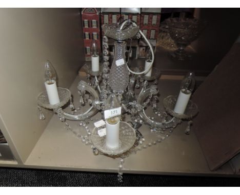 A ceiling light in the form of a chandelier, having Five bulbs.