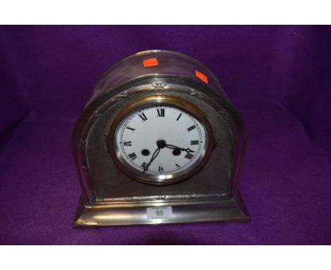 A vintage plated mantle clock of arched form with German movement.