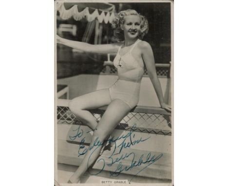 Betty Grable signed vintage real b/w photo publicity postcard shown seated in a bathing costume (produced for State Express C