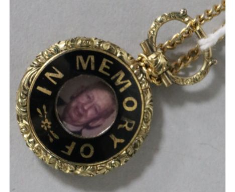A gold and enamel mounted memorial pendant, on a gilt metal chain, pendant 24mm.