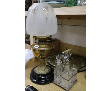 A brass oil lamp and a cruet and plated wares and two brass trays