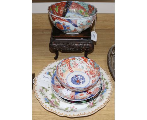 A Chinese carved hardwood stand, two Imari bowls and a similar dish and two other items, a modern Japanese plate and a Copela