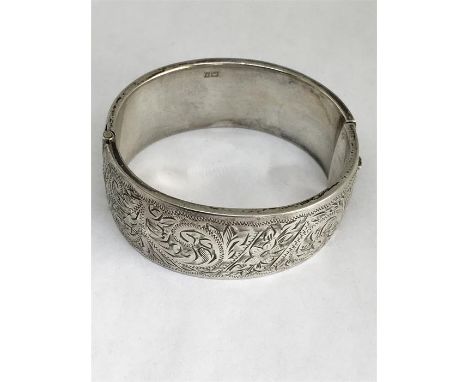 Hallmarked silver bangle Weight 34.1g. Measures 65 x58mm and 24mm at widest points.