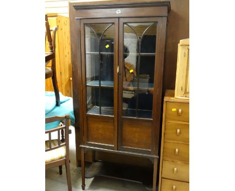 An Edwardian mahogany & decorated two-door display cabinet on raised feet with lower shelf