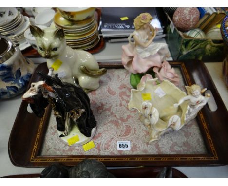 Four various ceramic figures on a lace decorated & inlaid tray