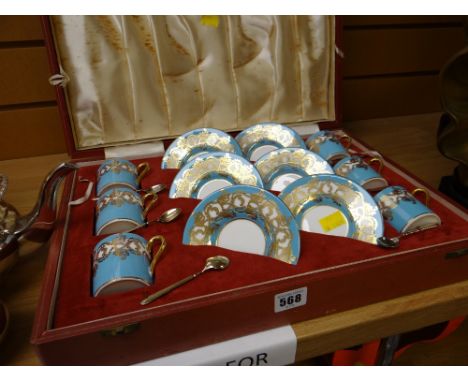 A cased Aynsley gilt &amp; blue decorated six coffee cans &amp; saucers together with silver gilt spoons